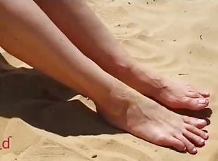 Cute girl takes of her sneakers and dirty socks while hiking in the desert