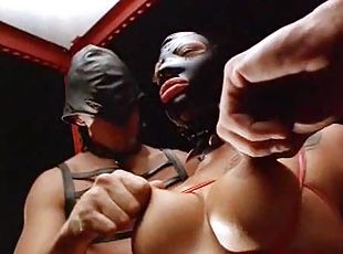 Bondage slut playing with cocks in dungeon