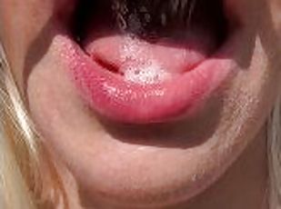 A nice teen is showing her wet smoky mouth tongue and uvula