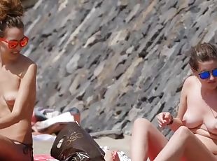 Topless beach hotties relax in sunglasses
