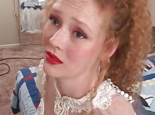 Redhead in wedding dress models her pussy